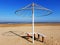Umbrella with frame on an empty beach.