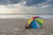 Umbrella and picnic basket against sea and beach