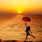 Umbrella woman jump and sunset silhouette