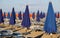 Umbrellas blue and orange in a sun-drenched Sea Beach