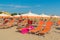 Umbrellas and chaise lounges on the beach of Rimini in Italy