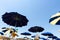 Umbrellas open on the beach against the blue summer sky