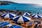 Umbrellas on a rocky sea beach in Leuca, Apulia, Italy