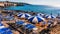 Umbrellas on a rocky sea beach in Leuca, Apulia, Italy