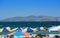 Umbrellas on the sandy beach a view of the sea and mountain on the opposite coast