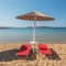 Umbrellas with sunbeds on beautiful sandy Santa Maria beach