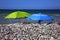 Umbrellas on a wild pebble beach