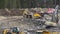 UMEA, SWEDEN - JULY 09, 2020: Two excavators and one bulldozer load two large dump trucks with big stones, work on new road