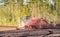 Umea, Sweden - May 17, 2019: Swedish farmer drives at the spring field, he uses a tractor to seed wheat. Modern Swedish ecological