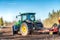 Umea, Sweden - May 17, 2019: Swedish farmer drives at the spring field, he uses a tractor to seed wheat. Modern Swedish ecological