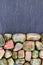 Unakite heap stones texture on half black stone background. Place for text