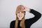 Unaltered candid emotional portrait of young happy woman with blonde long hair on grey background. Studio shot of trendy