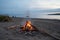 unattended campfire on a beach, smoke fading