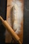 Unbaked loaf of bread with flour and rolling pin on cutting board