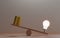 Unbalance of lightbulb glowing and golden coins money on seesaws for creative thinking idea can make more  treasure and money