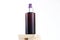 Unbranded brown cosmetic spray bottle on wood pieces podium on white background. Natural organic spa cosmetics, Spray concept.