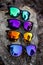 Unbranded colorful sunglasses on tree log