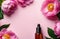 unbranded essence oil bottle on floral pink background with flowers blossoms and copyspace
