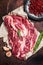 Unccoked marble black angus meat Steak on kitchen table, beef chuck roll steak. Dark background. Top view