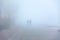 Uncertain silhouettes of people in heavy fog