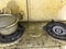 An uncleaned rusted dirty burned stainless steel top gas stove in house kitchen and Kitchen clean chemicals can clean this rubbish