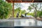 uncluttered steel table, craftsmen setting up a roof blurred in the background