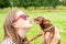 Unconditional love. Teenage girl kissing her brown toy-terrier d