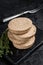 Uncooked Burgers cutlets made from plant based meat, raw vegan patties. Black background. Top view