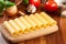 Uncooked cannelloni pasta on cutting board and ingredients