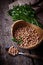 Uncooked chick-peas on wooden bowl