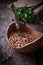 Uncooked chick-peas on wooden bowl