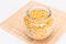 Uncooked Chifferi Rigati Pasta in Glass Jar on Bamboo Mat