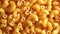 Uncooked chifferi rigati pasta, scattered dry macaroni - rotating background