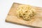 Uncooked Chinese egg noodle on wooden board