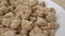 Uncooked dried soybeans close-up in a white bowl. Macro.