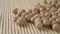 Uncooked dry chickpeas close-up on a bamboo mat.