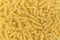 Uncooked or dry fusilli type of pasta textured background