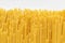 Uncooked durum fettuccine pasta on white background. Raw spaghetti or noodles