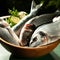 Uncooked fish with lime and herbs in a wooden bowl