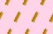 Uncooked fusilli pasta isolated on pink seamless background. Itallian spiral pasta close-up on pink seamless pattern