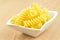 Uncooked fusilli in a small bowl, italian pasta