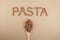 Uncooked Gluten-free pasta made from flaxseed flour is rich in fiber, iron, B vitamins and Omega-3. Inscription PASTA is lined