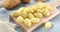 Uncooked gnocchi on cutting board