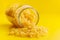 Uncooked gnocchi pasta. Raw italian pasta in jar on yellow background