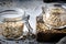 Uncooked green buckwheat groat in glass jar, healthy vegetarian food on gray kitchen table, copy space, selective focus