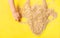 Uncooked healthy oat flakes on yellow background