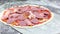 Uncooked Italian meat pizza.