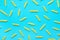 Uncooked Italian Penne Pasta Scattered on Blue Background. Food Pattern. Bright Vibrant Yellow Color.