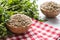 Uncooked lentils in wooden bowles with parsley herbs on kitchen