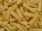 Uncooked maccheroni pasta tubes food texture background